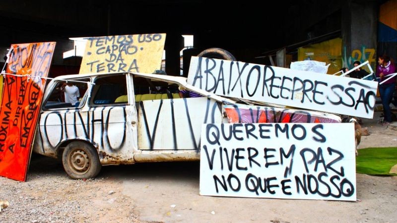'Temos usucapião da terra' e 'Queremos viver em paz no que é nosso', dizem cartazes de protesto na Favela do Moinho (Foto: Caio Castor via BBC News)