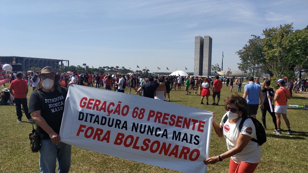 Casal carrega faixa em referência à ditadura militar, durante protesto contra governo Bolsonaro, em Brasília — Foto: Pedro Henrique Gomes/ G1