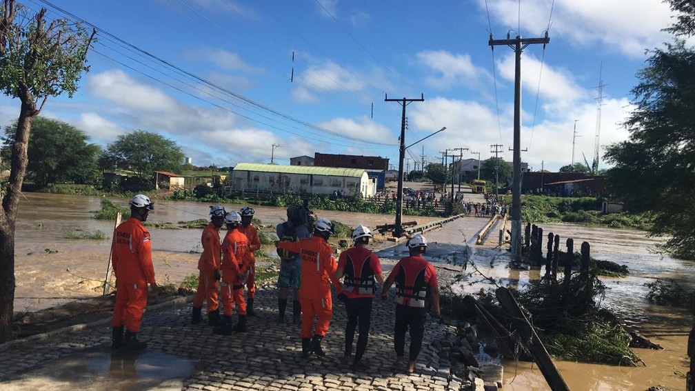 Bombeiros em Coronel João Sá, quando a água tomava a ponte na manhã deste sábado (13) — Foto: Alan Tiago/G1