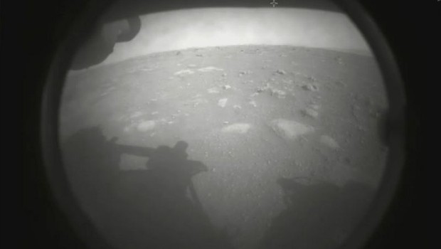 A primeira imagem de Marte fornecida pelo Perseverance chegou pouco depois do pouso e mostra a sombra de um dos 'braços' do robô (Foto: Nasa)