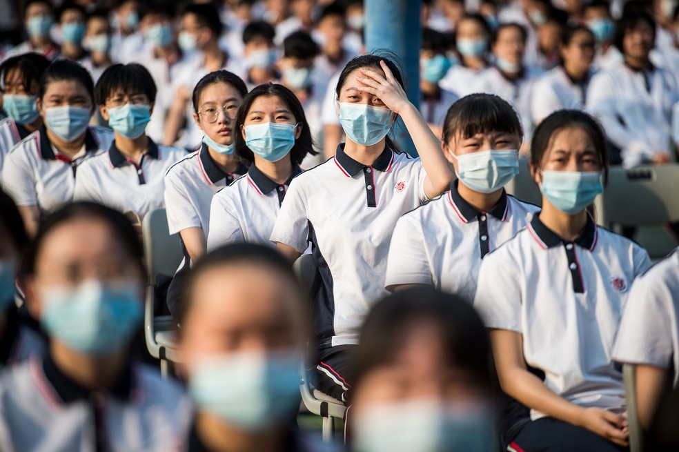 Alunos participam do 100º aniversário da fundação da Wuhan High School, no 1º dia do novo semestre em Wuhan, na província de Hubei, na China, nesta terça-feira (1º)  — Foto: AFP