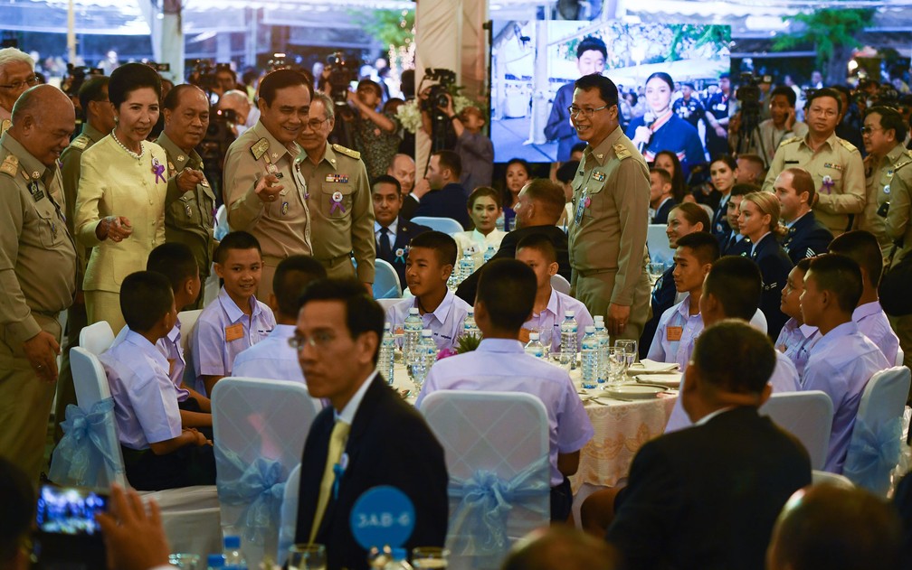 O primeiro-ministro tailandês Prayut Chan-O-Cha conversa com os meninos do time ‘Javalis Selvagens’ durante recepção em Bangcoc, na quinta-feira (6) (Foto: Romeo Gacad/AFP)