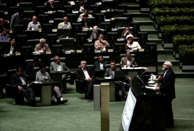 O chanceler do Irã, Mohammad Javad Zarif, fala no Parlamento do país defendendo o acordo nuclear fechado com seis potências na semana passada, após entregar o texto para revisão e votação pelos parlamentares nesta terça-feira (21) (Foto: Behrouz Mehri/AFP)