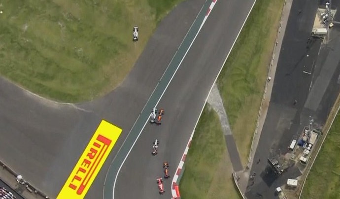 Visão aérea de Lewis Hamilton passando pela grama e incidente entre Nico Rosberg e Max Verstappen (Foto: Divulgação)