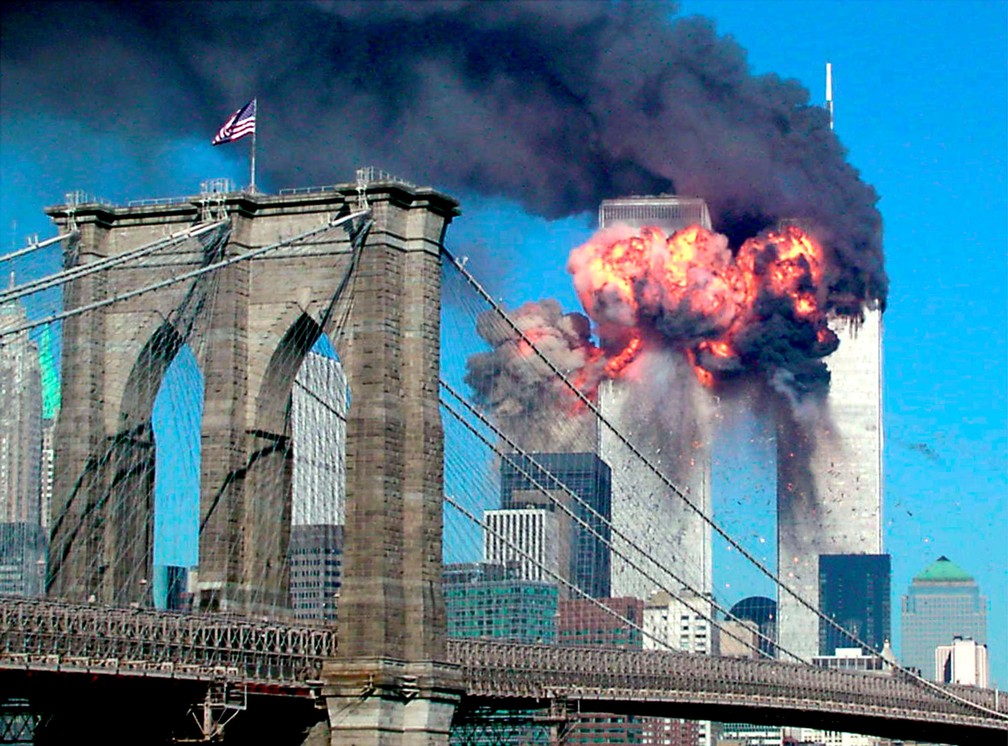 Por trás da Ponte do Brooklyn, a explosão do segundo avião a atingir o World Trade Center é vista de longe em Nova York durante o ataque terrorista em 11 de setembro de 2001 — Foto: Sara K. Schwittek/Reuters/Arquivo