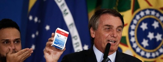 Jair Bolsonaro exibe caixa de cloroquina, medicamento sem eficácia comprovada contra a Covid, durante discurso  — Foto: Agência O Globo