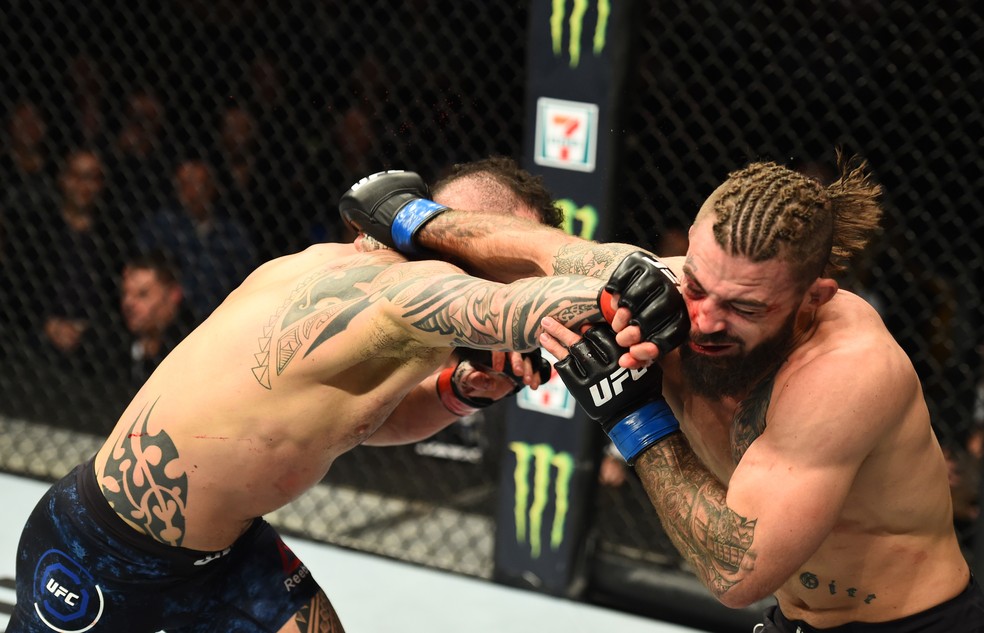 Santiago Ponzinibbio acerta o rosto de Mike Perry com um direto de direita (Foto: Josh Hedges/Getty Images)