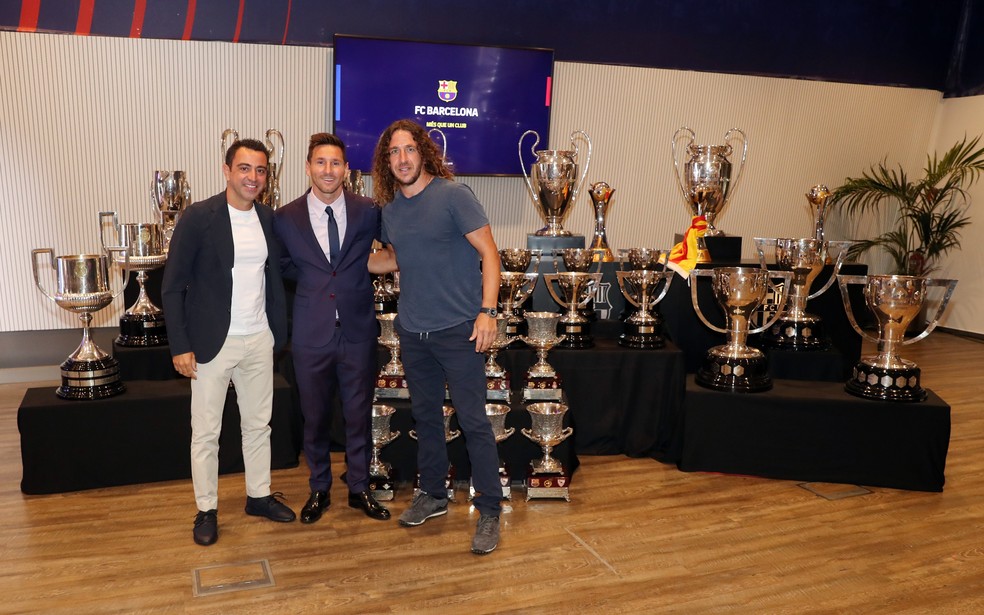 Ex-jogadores do Barça, Xavi e Puyol também foram à coletiva de Messi — Foto: Site oficial do Barcelona
