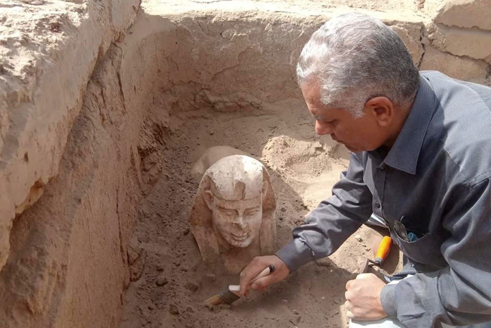 Uma foto sem data divulgada pelo Ministério de Antiguidades do Egito em 6 de março de 2023 mostra um trabalhador desenterrando a esfinge perto do Templo de Dendera, na província de Qina. — Foto: Ministério Egípcio de Antiguidades/AFP