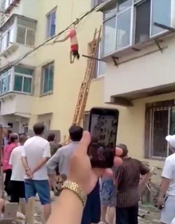 Chinesa fica presa em fios ao tentar fugir de apartamento pela janela