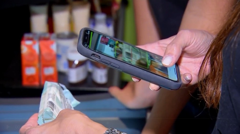 Empresas buscam facilitar pagamento dos clientes nos minimercados dos condomínios através do uso do celular — Foto: Reprodução/ TV TEM