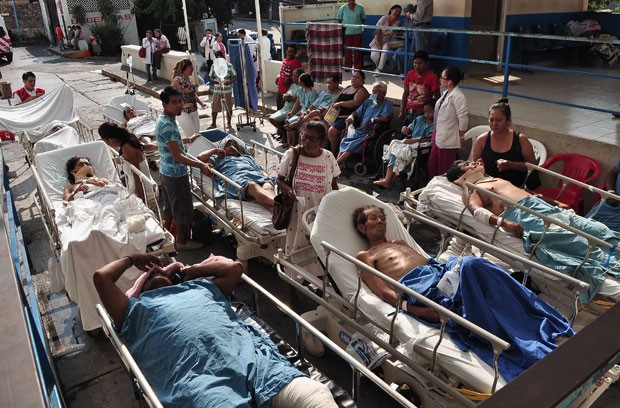 Pacientes de um hospital aguardam com familiares do lado de fora após o edifício ser esvaziado em Acapulco (Foto: Jesus Solano/Reuters)