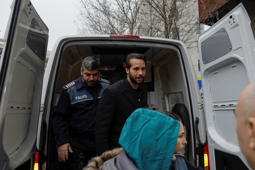 Tristan Tate é levado para interrogatório na sede da Direção de Investigação do Crime Organizado e do Terrorismo, em Bucareste, Romênia, em 26 de janeiro de 2023 — Foto: Inquam Photos/Octav Ganea via Reuters