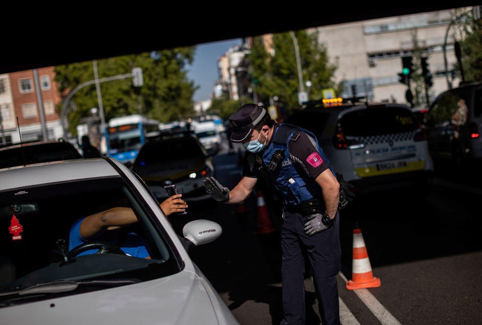 Motorista para em um posto de controle em Madri, na Espanha, nesta segunda-feira (21). Região está sob novas regras de restrição da circulação por causa do novo coronavírus  — Foto: Bernat Armangue/AP 