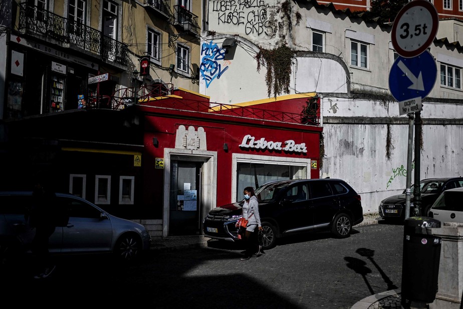 Mulher caminha em uma rua do centro de Lisboa