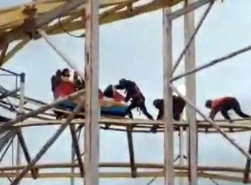 Funcionários do Tivoli Park tentam soltar carrinho preso na montanha-russa — Foto: Reprodução/TV Globo
