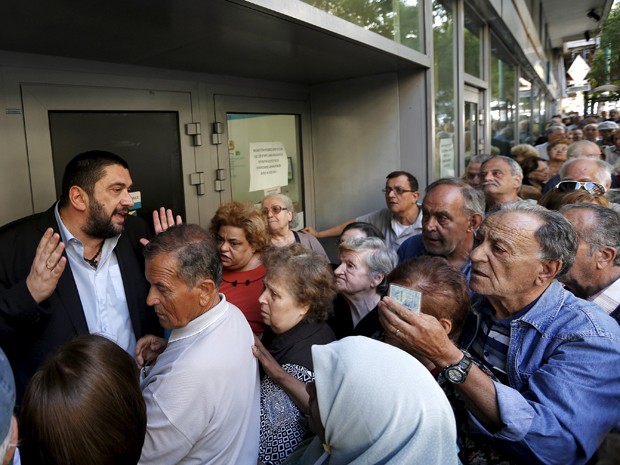 Pensionistas gregos se espremem em filas para sacar parte de seus benefícios  (Foto: Reuters)