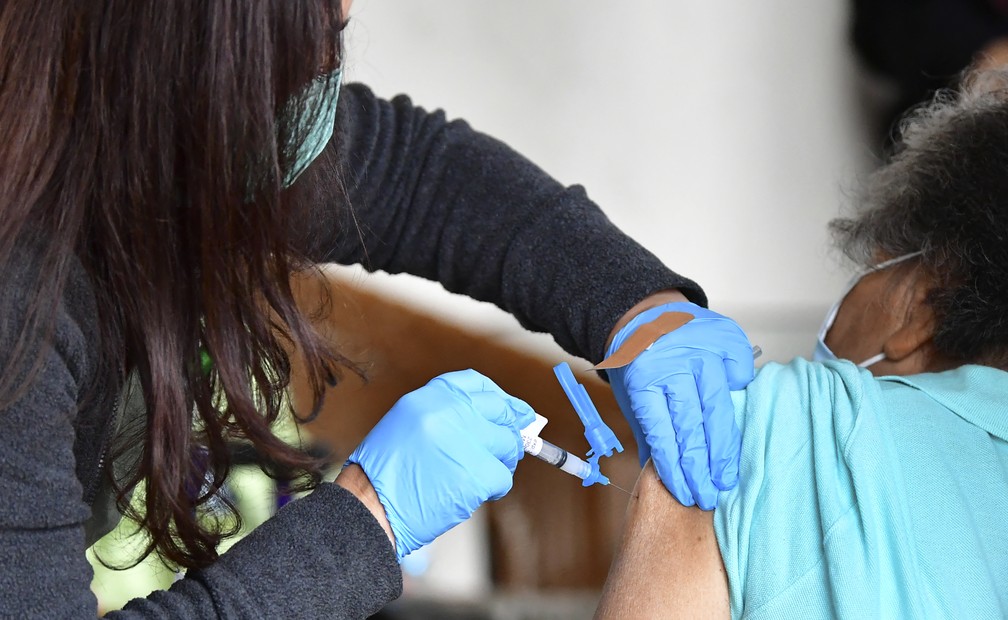 Enfermeira aplica segunda dose da vacina da Moderna em paciente em Los Angeles, nos Estados Unidos, no dia 3 de março. — Foto: Frederick J. Brown/AFP