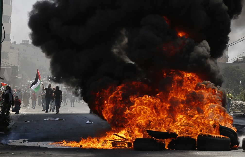 Barricada de pneus Ã© incendiada nesta terÃ§a-feira (15) durante protesto em Bethlehem, na CisjordÃ¢nia (Foto: Majdi Mohammed/ AP Photo)