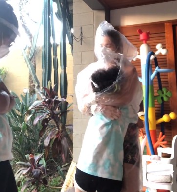 Atriz Samara Felippo usou capa de chuva para abraçar filhas com covid-19 (Foto: Reprodução/Instagram/Samara Felippo)