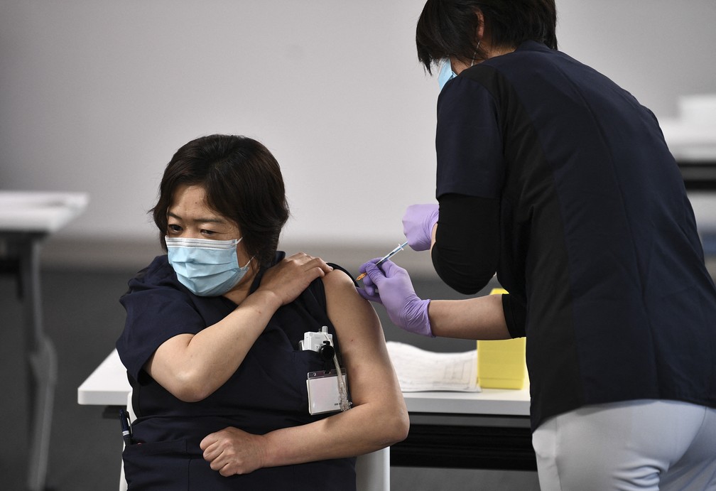 Profissional da saúde recebe vacina em Chiba, no Japão, nesta quarta-feira (17) — Foto: Kazuhiro Nogi/AFP