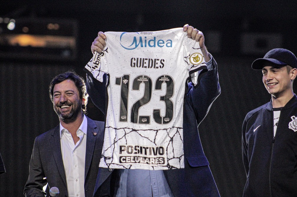 Duilio Monteiro Alves e MC Hariel ao lado de Roberto de Andrade com a camisa 123 de Roger Guedes, do Corinthians — Foto: Felipe Spzak/Corinthians