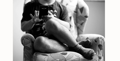 O jovem absorto em seu celular (Foto: Patricia Cançado)