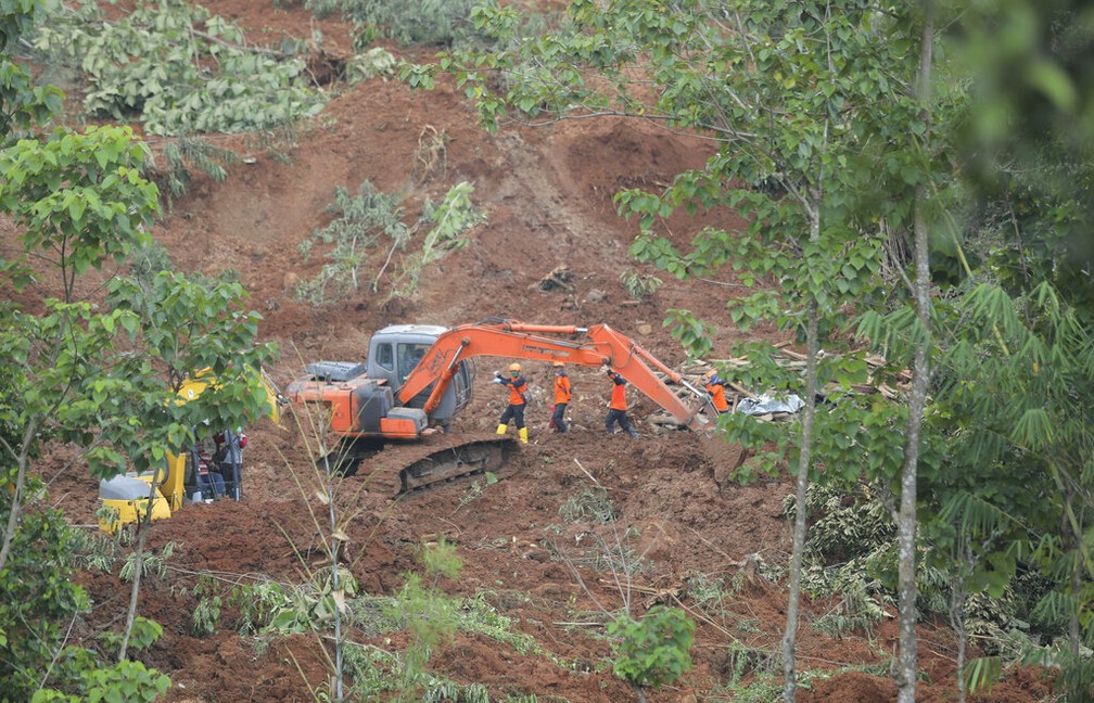 Socorristas procuram desaparecidos em um povoado atingido por um deslizamento de terra em Nganjuk, na ilha de Java, Indonésia, nesta segunda-feira (15) — Foto: Trisnadi/AP Photo