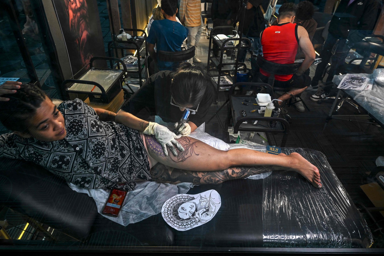 Mulher faz uma tatuagem no festival Kula, que reúne mais de 150 artistas de mais de 10 países em Mumbai — Foto: INDRANIL MUKHERJEE / AFP