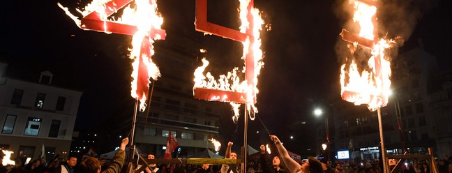 Manifestantes em Le Mans queimam o número 49.3, em referência ao artigo da manobra constitucional de Macron para aumentar a idade mínima de aposentadoria em dois anos na França — Foto: JEAN-FRANCOIS MONIER/AFP