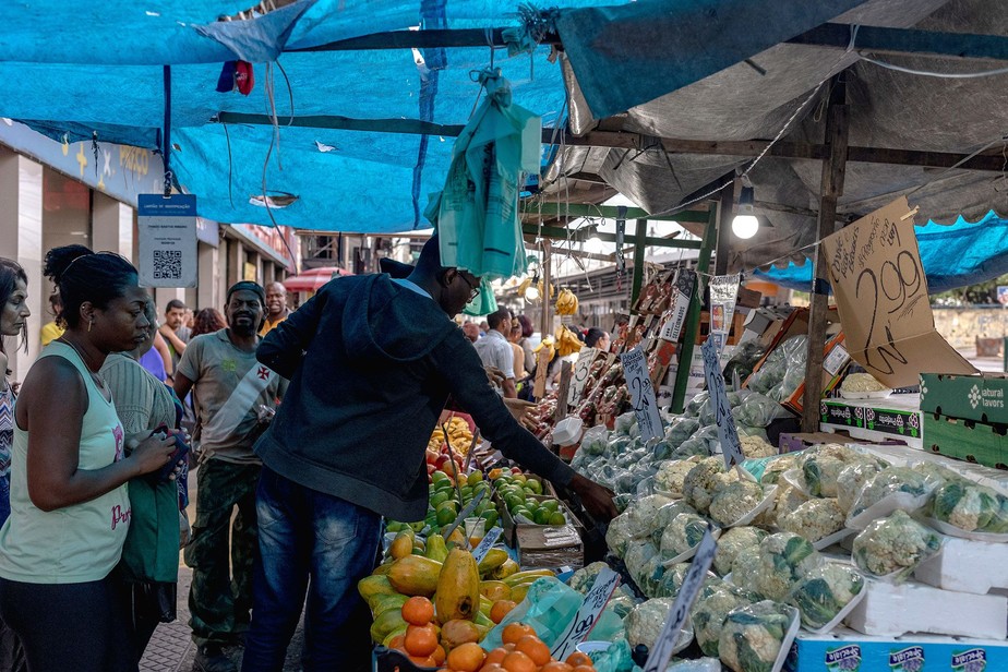 Compradores observam frutas e legumes à venda no Mercado Madureira, em Madureira, Rio de Janeiro