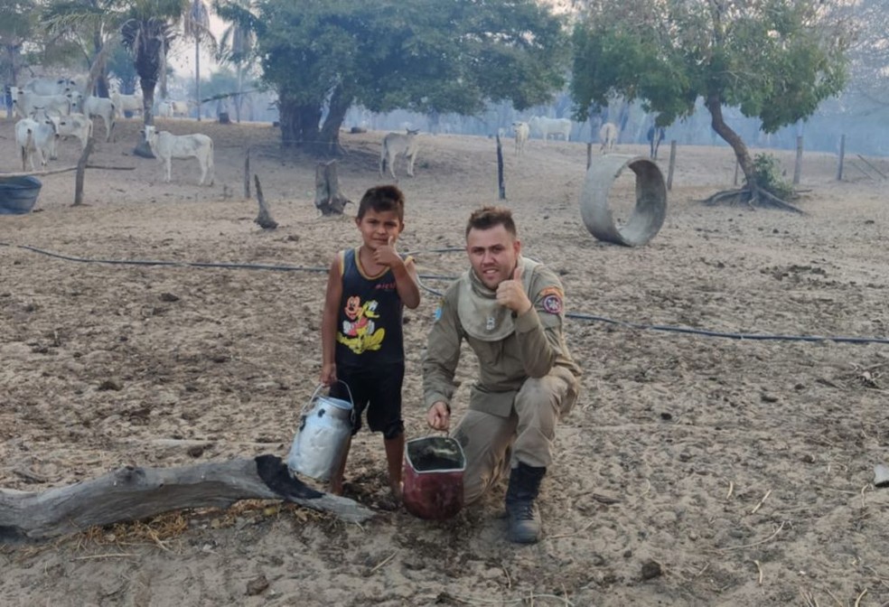 Outro bombeiro também tirou fotos com o menino que se voluntariou a apagar incêndios no Pantanal — Foto: Corpo de Bombeiros/Divulgação
