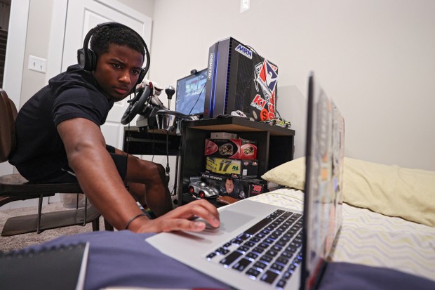 WASHINGTON, DC - MARCH 19: NASCAR Drive For Diversity Driver, Rajah Caruth checks his live-broadcast Twitch stream as he competes in the eTruck Series Night in America Powered by FilterTime, a live-online NASCAR Truck Series race on the iRacing platform,  (Foto: Getty Images)