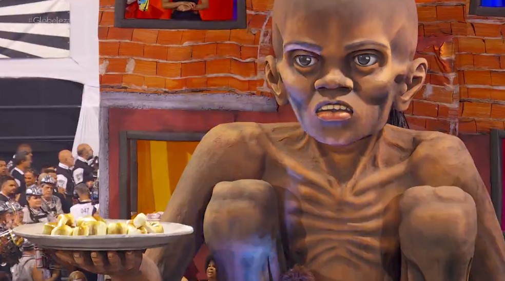 Menino com fome segurando prato de ossos em samba-enredo no carnaval deste ano — Foto: TV Globo