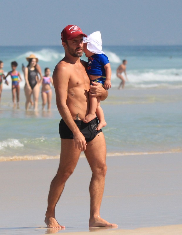 Roger Flores e o filho, Tom, na Praia da Barra da Tijuca (Foto: Fabricio Pioyani/AgNews)