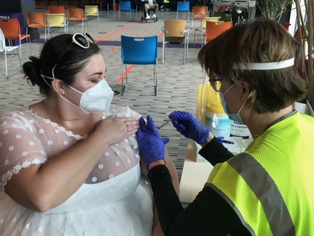 Pandemia adia casamento e mulher usa vestido de noiva para se vacinar (Foto: Reprodução/Twitter)