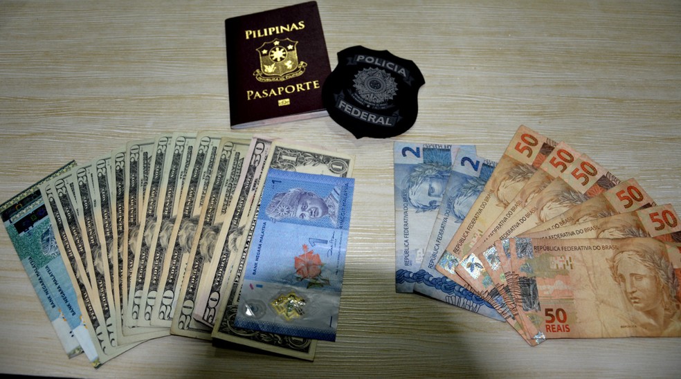 Dólares, reais e dinheiro da malásia foram encontrados com a enfermeira filipina, presa pela PF no Recife com cocaína escondida em embalagens de sabão líquido para lavar roupas — Foto: Polícia Federal/Divulgação