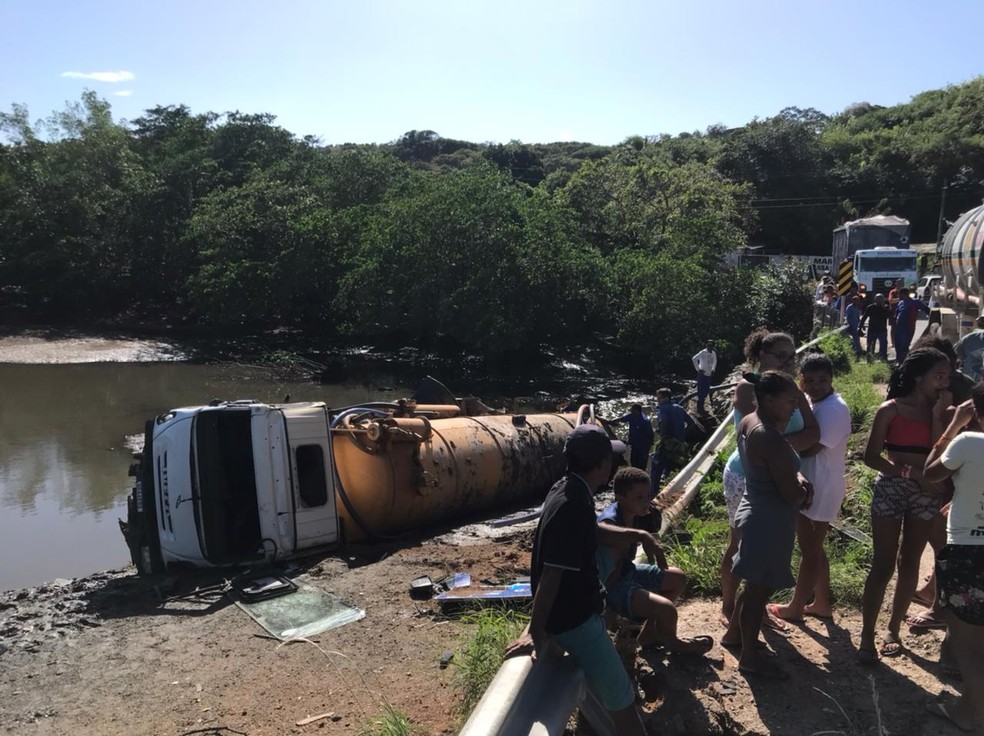 Curiosos veem caminhão limpa-fossas caído em rio de Natal. — Foto: Geraldo Jerônimo/Inter TV Cabugi