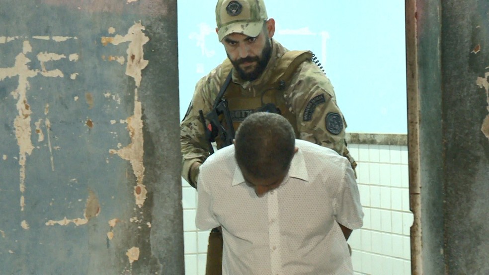 Ademir ao sair do DML de cabeça baixa (Foto: Reprodução/ TV Gazeta)