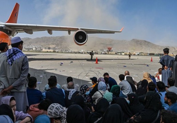 Afegãos foram correndo para o aeroporto de Cabul na segunda-feira (16/8) na esperança de deixar o país (Foto: AFP via BBC)