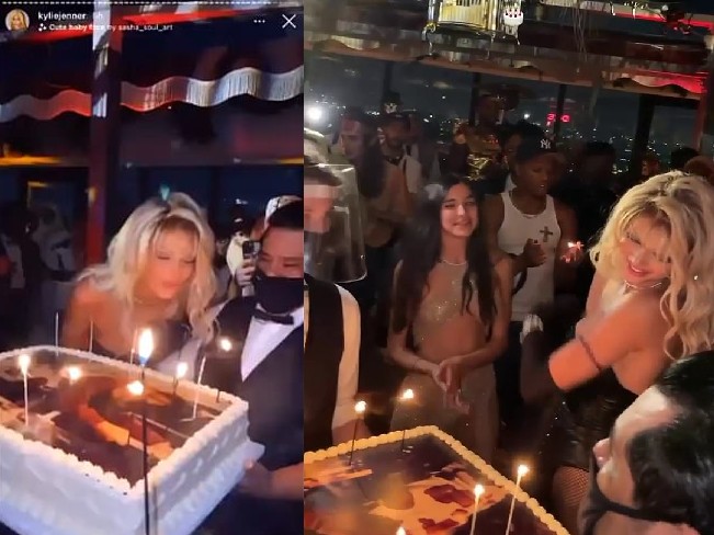 Em um vídeo, Jenner, vestida como Pamela Anderson, aparece soprando as velas de seu bolo de aniversário, enquanto um garçom usando máscara de proteção segurava o bolo e tentava desviar do 'sopro' (Foto: Reprodução)