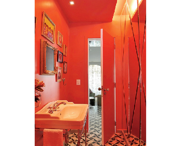 O lavabo projetado pelo designer Marcelo Rosenbaum tem teto e parede vermelhos. A monocromia é reforçada pelo espelho, que reflete o tom intenso (Foto: Marcelo Magnani/Casa e Jardim)