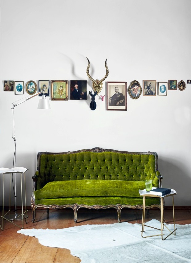Equilíbrio. No quarto principal, o verde vivo do veludo usado no antigo sofá francês é o grande atrativo. Acima dele, uma organização meticulosa e inesperada de porta-retratos (Foto: Greg Cox / Bureaux)