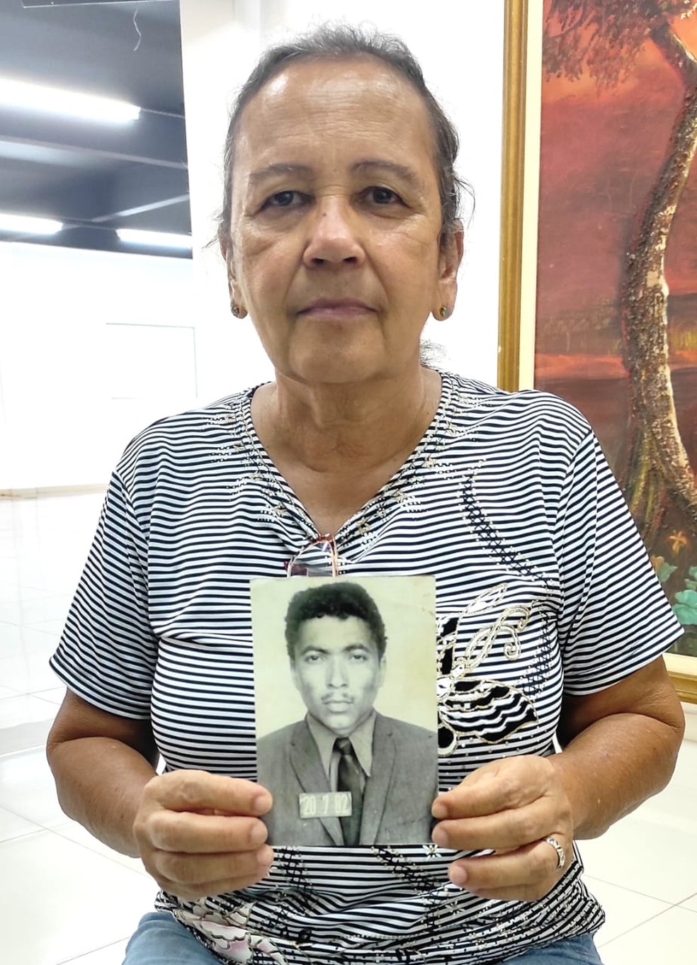 Maria Rosalina segura a foto do irmão que desapareceu há mais de 30 anos — Foto: Geisy Negreiros/ g1