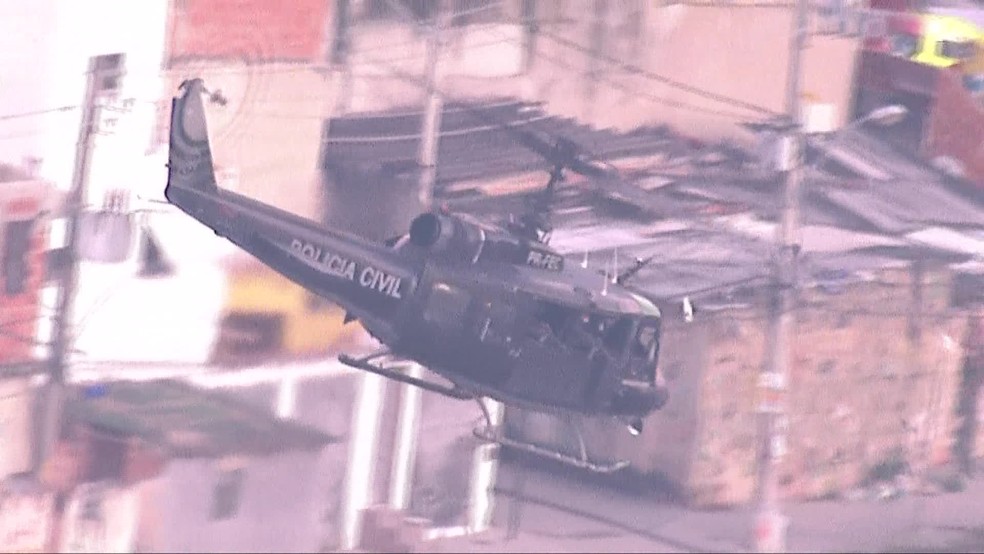 Helicóptero blindado sobrevoa a Cidade de Deus; na semana passada, bomba de efeito moral foi jogada em rua da comunidade — Foto: Reprodução/TV Globo