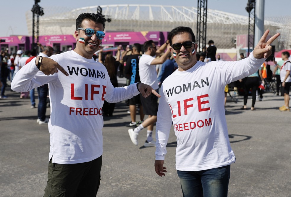 Torcedores do Irã usam camiseta com as palavras ‘Mulher Vida Liberdade’ do lado de fora do estádio antes do jogo — Foto: REUTERS/Suhaib Salem
