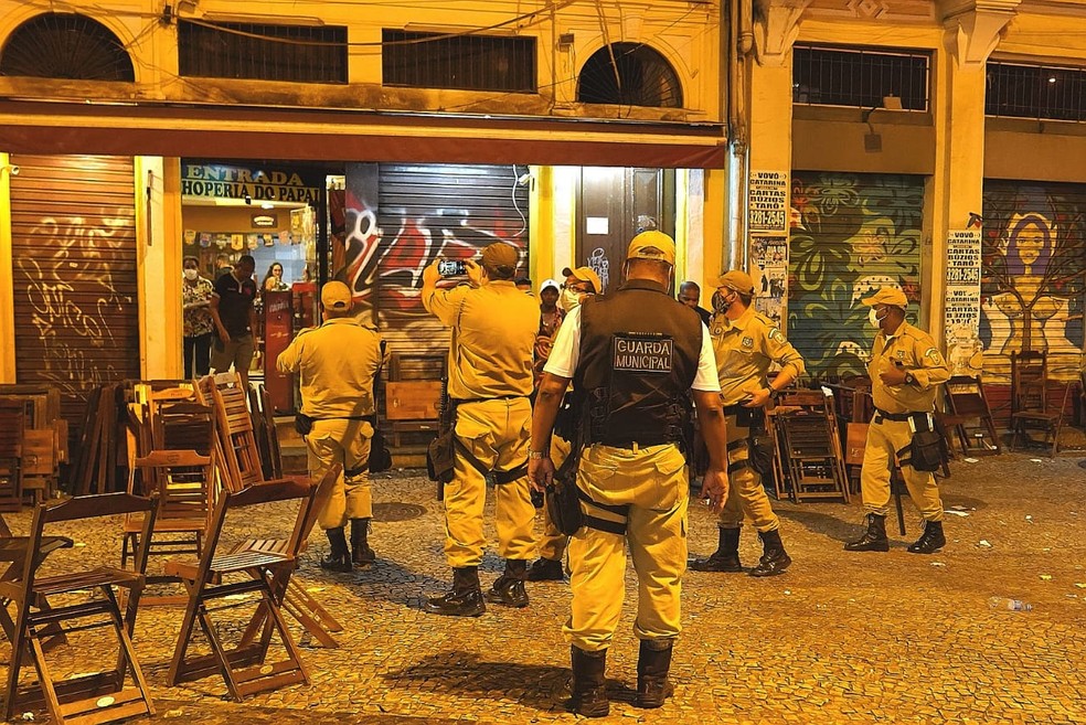 Guardas Municipais fotografam a infração antes da notificação de um bar na Lapa — Foto: Marcos Serra Lima/G1