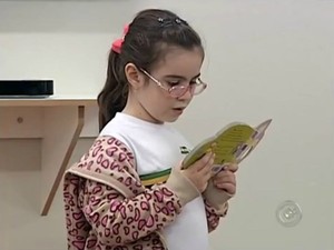 A estudante Gabriela Santos, de 6 anos, concentrada na leitura (Foto: Reprodução / TV TEM)