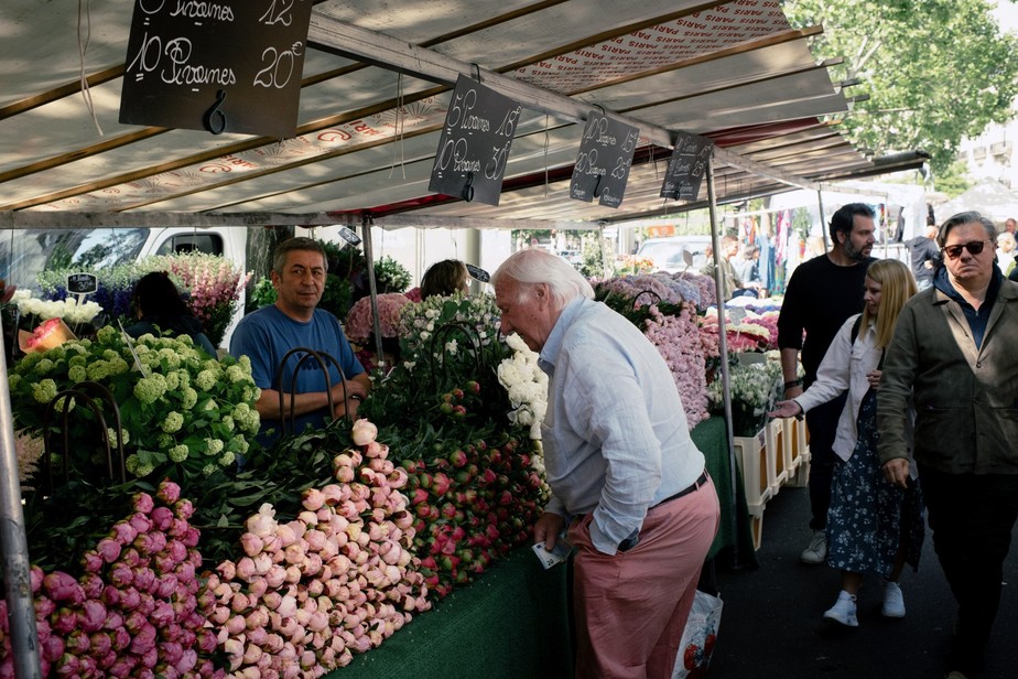 Homem confere os preços das flores em mercado em Paris em contexto de inflação: para Krastev, recessão econômica na UE será pior que na última crise financeira