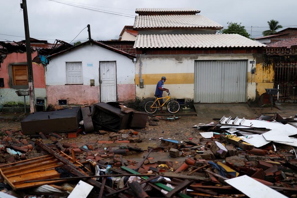 Um homem passa pelos escombros de casas destruídas pelas enchentes em Itambé, no sul da Bahia,    — Foto: Amanda Perobelli/Reuters